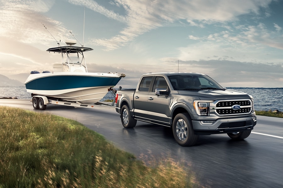 A Ford F 1 50 pulls a boat on a trailer.